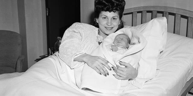 In this Jan. 10, 1944 file photo, Nancy Sinatra holds her newborn son, Frank, at Margaret Hague Maternity Hospital in Jersey City, N.J.