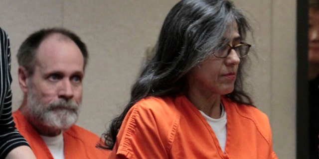 FILE - In this June 2, 2011 file photo, Nancy Garrido takes a seat as her husband, Phillip Garrido, background, looks on at the El Dorado County Superior Court in Placerville, Calif. Disturbing new video released Tuesday, Aug. 2, 2011, shows Nancy Garrido, the wife of convicted kidnapper and rapist Phillip Garrido, luring a young girl into the couple's van, asking her to do the splits and videotaping her, two years after the couple kidnapped 11-year-old Jaycee Dugard.