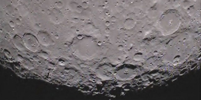 Caption:One of NASA's twin Grail spacecraft has returned its first unique picture of the far side of the moon, an image that shows shadowed craters at the moon's south pole.