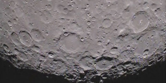 Caption:One of NASA's twin Grail spacecraft has returned its first unique picture of the far side of the moon, an image that shows shadowed craters at the moon's south pole.