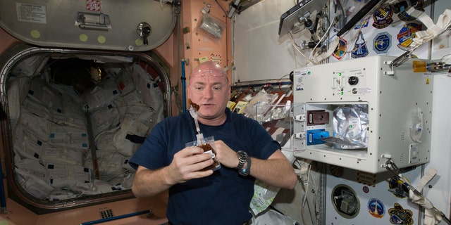 File photo: NASA astronaut Scott Kelly enjoys his first drink from the new ISSpresso machine aboard the International Space Station, May 3, 2016. The espresso device allows crews to make tea, coffee, broth, or other hot beverages they might enjoy. (REUTERS/NASA/Handout)