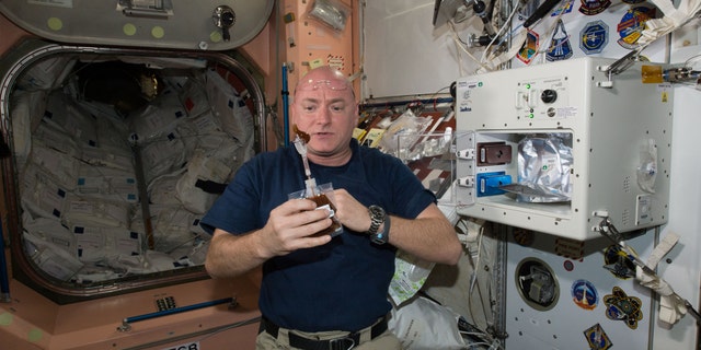 File photo: NASA astronaut Scott Kelly enjoys his first drink from the new ISSpresso machine aboard the International Space Station, May 3, 2016. The espresso device allows crews to make tea, coffee, broth, or other hot beverages they might enjoy. (REUTERS/NASA/Handout)