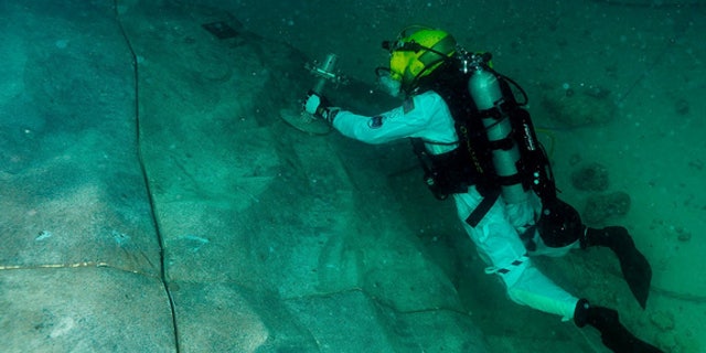 Steve Squyers maneuvers to an anchor point on "asteroid" rock wall during one of the extravehicular activities.