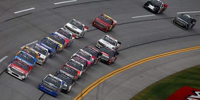 TALLADEGA, AL - OCTOBER 24: Timothy Peters, driver of the #17 Red Horse Racing Toyota, and Brandon Jones, driver of the #33 Wittichen Supply Company Chevrolet, lead the field to a restart during the NASCAR Camping World Truck Series fred's 250 at Talladega Superspeedway on October 24, 2015 in Talladega, Alabama. (Photo by Tom Pennington/Getty Images)