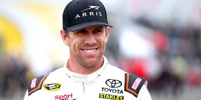 LONG POND, PA - JUNE 03: Carl Edwards, driver of the #19 ARRIS Toyota, stands in the garage area during practice for the NASCAR Sprint Cup Series Axalta "We Paint Winners" 400 at Pocono Raceway on June 3, 2016 in Long Pond, Pennsylvania. (Photo by Sean Gardner/Getty Images)