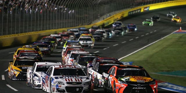 CHARLOTTE, NC - MAY 29: Martin Truex Jr., driver of the #78 Bass Pro Shops/Tracker Toyota, and Jimmie Johnson, driver of the #48 Lowe's Patriotic Chevrolet, lead a restart during the NASCAR Sprint Cup Series Coca-Cola 600 at Charlotte Motor Speedway on May 29, 2016 in Charlotte, North Carolina. (Photo by Jerry Markland/NASCAR via Getty Images)