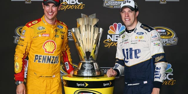 RICHMOND, VA - SEPTEMBER 10: Brad Keselowski, driver of the #2 Miller Lite Ford, and Joey Logano, driver of the #22 Shell Pennzoil Ford, pose with the NASCAR Sprint Cup trophy after the NASCAR Sprint Cup Series Federated Auto Parts 400 at Richmond International Raceway on September 10, 2016 in Richmond, Virginia. (Photo by Sarah Crabill/Getty Images)