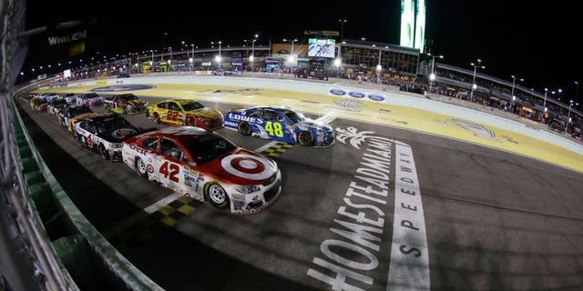 HOMESTEAD, FL - NOVEMBER 20: Kyle Larson, driver of the #42 Target Chevrolet, and Jimmie Johnson, driver of the #48 Lowe's Chevrolet, lead the field on the final restart during the NASCAR Sprint Cup Series Ford EcoBoost 400 at Homestead-Miami Speedway on November 20, 2016 in Homestead, Florida. (Photo by Sarah Crabill/Getty Images)