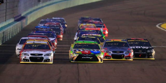 HOMESTEAD, FL - NOVEMBER 22: Kevin Harvick, driver of the #4 Budweiser/Jimmy John's Chevrolet, Kyle Busch, driver of the #18 M&M's Crispy Toyota, Jeff Gordon, driver of the #24 AXALTA Chevrolet, and Martin Truex Jr., driver of the #78 Furniture Row/Denver Mattress Chevrolet, lead the field during a restart during the NASCAR Sprint Cup Series Ford EcoBoost 400 at Homestead-Miami Speedway on November 22, 2015 in Homestead, Florida. (Photo by Chris Trotman/NASCAR via Getty Images)