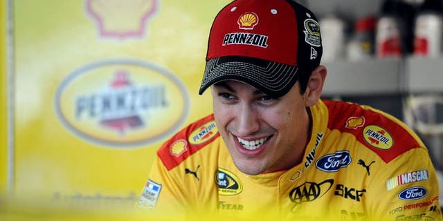 KANSAS CITY, KS - OCTOBER 14: Joey Logano, driver of the #22 Shell Pennzoil Ford, stands in the garage area during practice for the NASCAR Sprint Cup Series Hollywood Casino 400 at Kansas Speedway on October 14, 2016 in Kansas City, Kansas. (Photo by Rainier Ehrhardt/NASCAR via Getty Images)