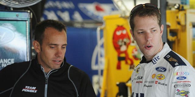 KANSAS CITY, KS - OCTOBER 15: Brad Keselowski, driver of the #2 Miller Lite Ford, and crew chief Paul Wolfe talk in the garage during practice for the NASCAR Sprint Cup Series Hollywood Casino 400 at Kansas Speedway on October 15, 2016 in Kansas City, Kansas. (Photo by Rainier Ehrhardt/NASCAR via Getty Images)
