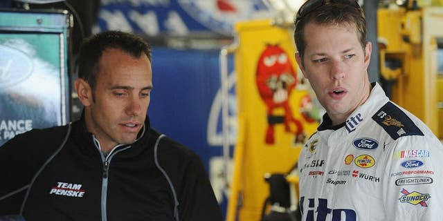 KANSAS CITY, KS - OCTOBER 15: Brad Keselowski, driver of the #2 Miller Lite Ford, and crew chief Paul Wolfe talk in the garage during practice for the NASCAR Sprint Cup Series Hollywood Casino 400 at Kansas Speedway on October 15, 2016 in Kansas City, Kansas. (Photo by Rainier Ehrhardt/NASCAR via Getty Images)