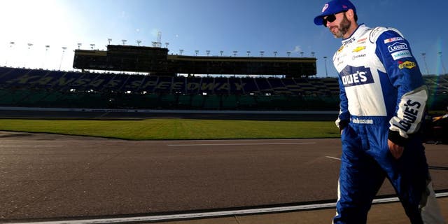 KANSAS CITY, KS - OCTOBER 14: Jimmie Johnson, driver of the #48 Lowe's Chevrolet, walks on the grid prior to qualifying for the NASCAR Sprint Cup Series Hollywood Casino 400 at Kansas Speedway on October 14, 2016 in Kansas City, Kansas. (Photo by Jeff Curry/Getty Images)