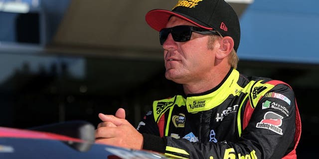 BROOKLYN, MI - AUGUST 26: Clint Bowyer, driver of the #15 5-hour Energy Chevrolet, stands on the grid during qualifying for the NASCAR Sprint Cup Series Pure Michigan 400 at Michigan International Speedway on August 26, 2016 in Brooklyn, Michigan. (Photo by Rey Del Rio/Getty Images)