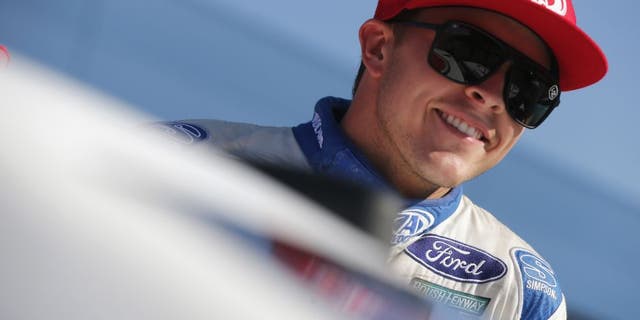 BROOKLYN, MI - AUGUST 26: Trevor Bayne, driver of the #6 AdvoCare Ford, smiles during qualifying for the NASCAR Sprint Cup Series Pure Michigan 400 at Michigan International Speedway on August 26, 2016 in Brooklyn, Michigan. (Photo by Brian Lawdermilk/NASCAR via Getty Images)