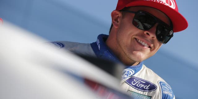 BROOKLYN, MI - AUGUST 26: Trevor Bayne, driver of the #6 AdvoCare Ford, smiles during qualifying for the NASCAR Sprint Cup Series Pure Michigan 400 at Michigan International Speedway on August 26, 2016 in Brooklyn, Michigan. (Photo by Brian Lawdermilk/NASCAR via Getty Images)