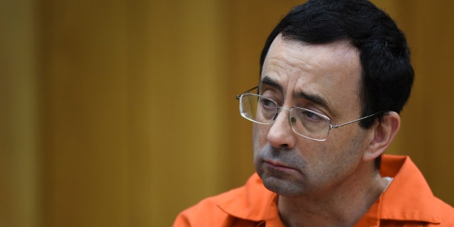 Larry Nassar listens as Rachael Denhollander gives her victim impact statement on Feb. 2.
