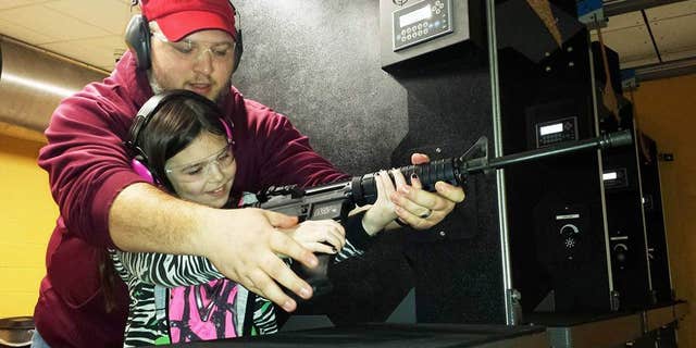 Natalie Gibson practices her shot with father Nathan.