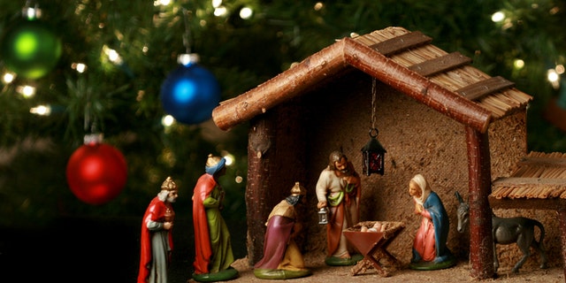 nativity scene with christmas tree background