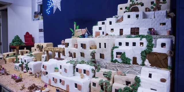 The six-foot-tall, three-foot-wide structure is made entirely out of fruit cake, frosting and marzipan.