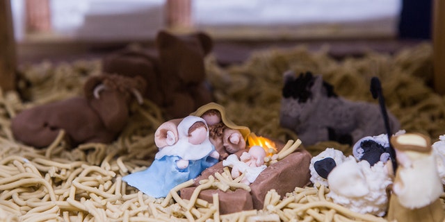 In the middle of the nativity, Mary, Joseph and baby Jesus sit surrounded by sheep, cows and the three wise men.