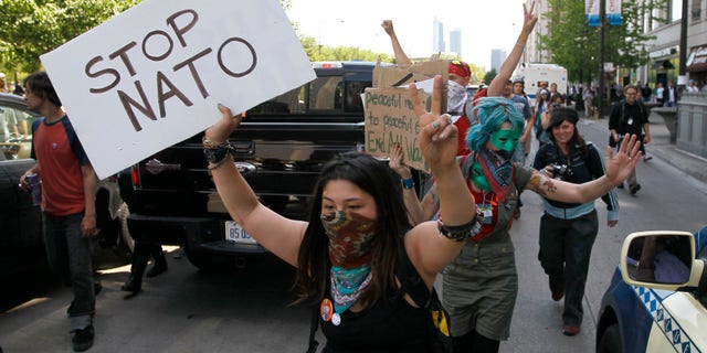 May 18, 2012: Protesters block traffic on Michigan Ave., as they march through the city during a demonstration, ahead of this weekends' NATO summit in Chicago.