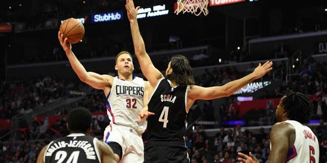 Nov 14, 2016; Los Angeles, CA, USA; Los Angeles Clippers forward Blake Griffin (32) shoots against Brooklyn Nets forward Luis Scola (4) in the first half of a NBA basketball game at Staples Center. Mandatory Credit: Richard Mackson-USA TODAY Sports
