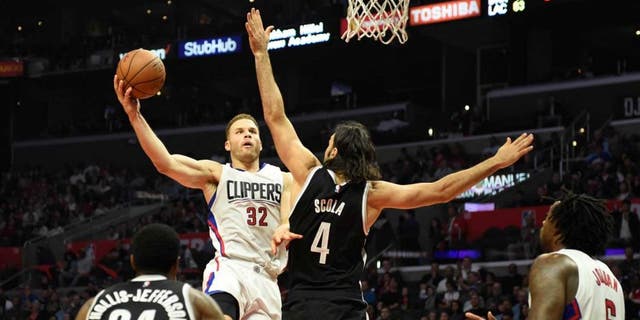 Nov 14, 2016; Los Angeles, CA, USA; Los Angeles Clippers forward Blake Griffin (32) shoots against Brooklyn Nets forward Luis Scola (4) in the first half of a NBA basketball game at Staples Center. Mandatory Credit: Richard Mackson-USA TODAY Sports