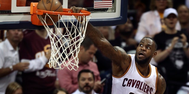 June 8, 2016: Cleveland Cavaliers forward LeBron James dunks against the Golden State Warriors during the second half of Game 3 of the NBA Finals in Cleveland.