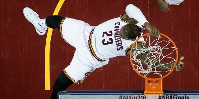 June 16, 2016: Cleveland Cavaliers forward LeBron James dunks against the Golden State Warriors during the first half of Game 6 of the NBA Finals in Cleveland