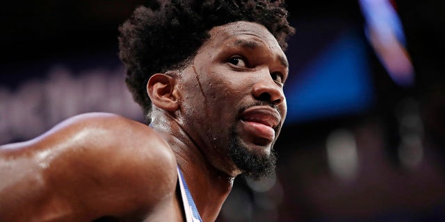 Philadelphia 76ers' Joel Embiid (21) talks to spectators during the second half of the team's NBA basketball game against the New York Knicks in New York.
