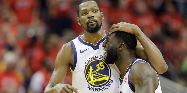 Golden State Warriors forward Kevin Durant (35) celebrates with teammate Draymond Green (23) during the second half in Game 7 of the NBA basketball Western Conference finals against the Houston Rockets, Monday, May 28, 2018, in Houston. (AP Photo/David J. Phillip)