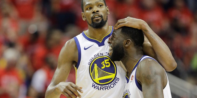 Golden State Warriors forward Kevin Durant (35) celebrates with teammate Draymond Green (23) during the second half in Game 7 of the NBA basketball Western Conference finals against the Houston Rockets, Monday, May 28, 2018, in Houston. (AP Photo/David J. Phillip)
