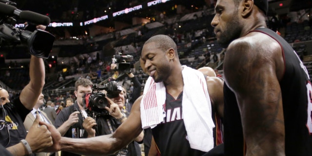 June 13, 2013: Miami Heat's Dwyane Wade, left, and LeBron James leave the floor after beating San Antonio Spurs at Game 4 of the NBA Finals basketball series in San Antonio.