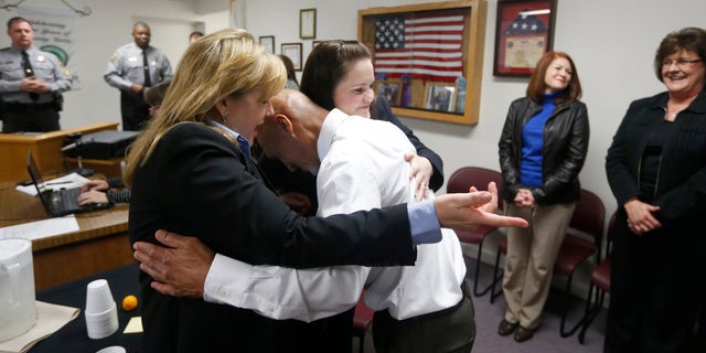 Jan. 23, 2015: Christine Mumma, director of the North Carolina Center on Actual Innocence, left, and Cheryl Sullivan, staff attorney, hug Joseph Sledge after a special session of superior court in Whiteville, N.C.