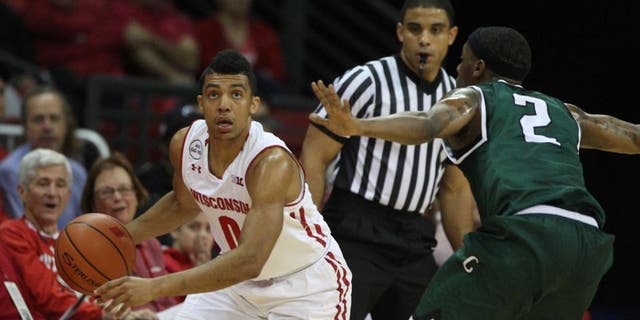 Nov 17, 2016; Madison, WI, USA; Wisconsin Badgers guard D'Mitrik Trice (0) controls the ball as Chicago State Cougars guard Clemmlye Owens V (2) defends at the Kohl Center. Mandatory Credit: Mary Langenfeld-USA TODAY Sports