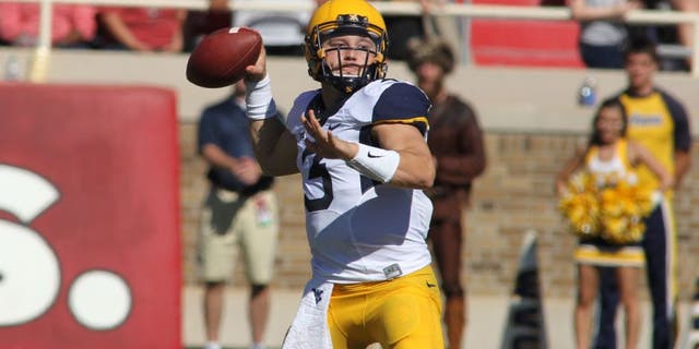 Oct 15, 2016; Lubbock, TX, USA; West Virginia Mountaineers quarterback Skyler Howard (3) prepares to make a throw against the Texas Tech Red Raiders in the first half at Jones AT&amp;T Stadium. Mandatory Credit: Michael C. Johnson-USA TODAY Sports
