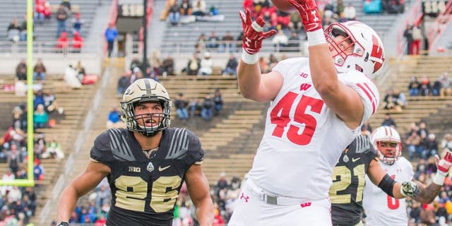 Nov 19, 2016; West Lafayette, IN, USA; Wisconsin Badgers fullback Alec Ingold (45) scores a touchdown while Purdue Boilermakers safety C.J. Parker (26) defends in the second quarter of the game at Ross Ade Stadium. Mandatory Credit: Trevor Ruszkowski-USA TODAY Sports