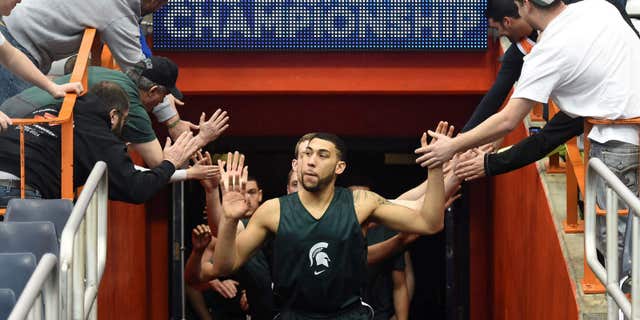 March 26, 2015: The Michigan State basketball team enters the Carrier Dome before practice for an east regional semifinal in the NCAA Tournament.