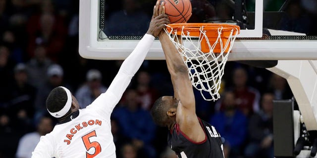 Mar. 20, 2014: Cincinnati's Justin Jackson (5) tries to stop a shot by Harvard's Steve Moundou-Missi in the first half during a second-round game of the NCAA college basketball tournament in Spokane, Wash.