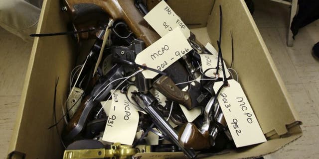 Jan. 26, 2013: Hand guns are seen in a box in Trenton, N.J., during a gun buyback event.