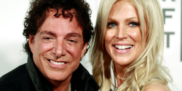Neal Schon of the band Journey arrives with Michaele Salahi for the premiere of "Don't Stop Believin': Everyman's Journey" during the Tribeca Film Festival in New York, April 19, 2012.