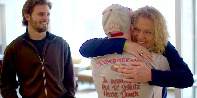 In this Friday, April 1, 2016 image made from video provided by Nebraska Medicine, Lisa Swanson meets Terry Hooper for the first time after the Nebraska man received her son's heart, in Omaha, Neb. Hooper received the heart on Dec. 10, 2012, three days after 18-year-old Levi Schulz of Horace, North Dakota, died in a car crash. Schulz's twin brother, Shelby Schulz is at left.(Dave Hynek/ Nebraska Medicine via AP)