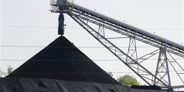 FILE - This June 2, 2014 file photo shows a hill of coal at the North Omaha Station, a coal-burning power station, in Omaha, Neb. President Barack Obama presented his final plan for carbon dioxide reduction targets on Monday, Aug. 3, 2015, which would reduce emissions 32 percent below 2005 levels by 2030. (AP Photo/Nati Harnik, file)