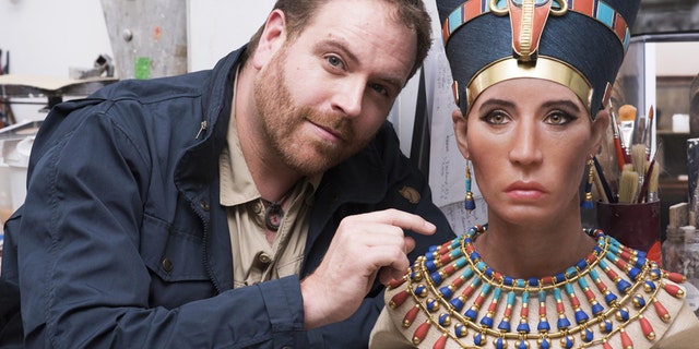 Josh Gates with the bust of Queen Nefertiti.