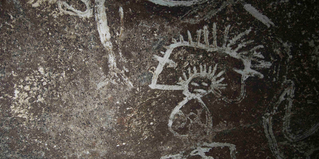 A depiction of a man rubbed into a Mona Island cave wall at least 500 years ago.