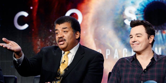 January 13, 2014. Host Neil DeGrasse Tyson (L) and Seth MacFarlane, executive producer of  "Cosmos," participate in Fox Broadcasting Company's part of the Television Critics Association (TCA) Winter 2014 presentations in Pasadena, California.