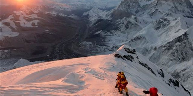 In this May 18, 2013 file photo released by mountain guide Adrian Ballinger of Alpenglow Expeditions, climbers make their way to the summit of Mount Everest, in the Khumbu region of the Nepal Himalayas.