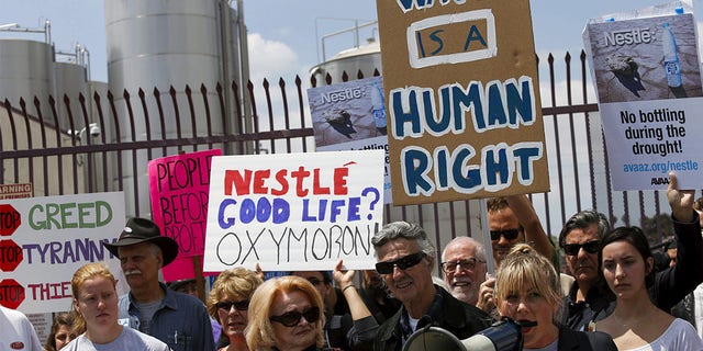 Protestors gather outside a Nestle Arrowhead water bottling plant in Los Angeles.