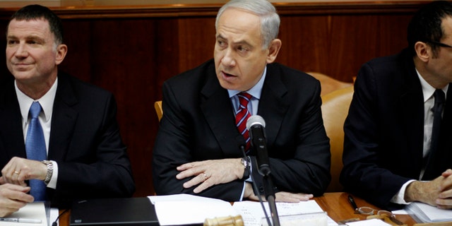 Jan. 27, 2013: Israeli Prime Minister Benjamin Netanyahu, center, heads the weekly Cabinet meeting at his Jerusalem office. Sitting left is Cabinet minister Yuli Edelstein.